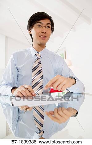 Young Asian businessman signing contracts View Large Photo Image Stock Photograph - Young Asian businessman signing contracts. Fotosearch
