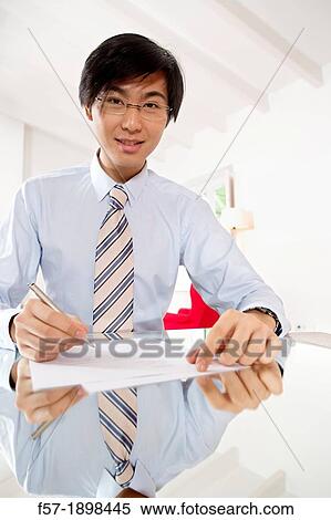 Young Asian businessman signing contracts View Large Photo Image Stock Photography - Young Asian businessman signing contracts. Fotosearch