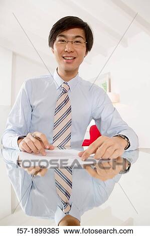 Young Asian businessman signing contracts View Large Photo Image Stock Photography - Young Asian businessman signing contracts. Fotosearch