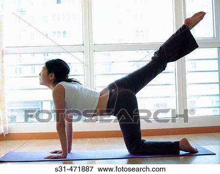 young asian girl practicing yoga at home View Large Photo Image Stock Photo - young asian girl practicing yoga at home. Fotosearch