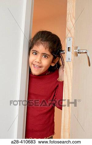 Young Asian (Indian) girl looking through half open door View Large Photo Image Stock Image - Young Asian (Indian) girl looking through half open door. Fotosearch