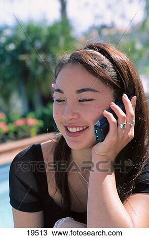 Young asian lady on the phone View Large Photo Image Stock Image - Young asian lady on the phone. Fotosearch