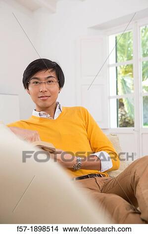 Young Asian man studying a foreign language book View Large Photo Image Picture - Young Asian man studying a foreign language book. Fotosearch
