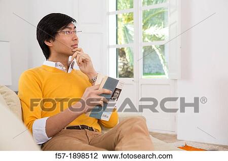 Young Asian man studying a foreign language book View Large Photo Image Stock Image - Young Asian man studying a foreign language book. Fotosearch