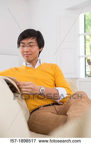 Young Asian man studying a foreign language book View Large Photo Image Stock Photo - Young Asian man studying a foreign language book. Fotosearch