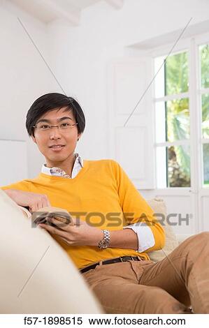 Young Asian man studying a foreign language book View Large Photo Image Stock Photography - Young Asian man studying a foreign language book. Fotosearch