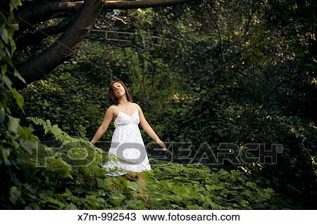 Young Asian woman enjoying the forest alone View Large Photo Image Stock Image - Young Asian woman enjoying the forest alone. Fotosearch