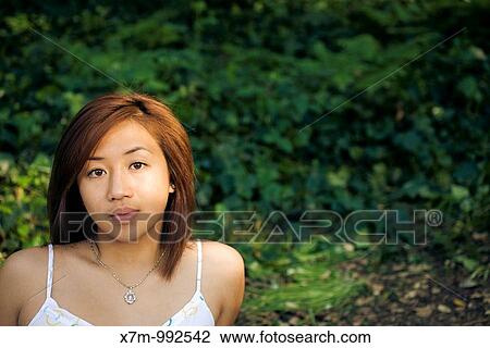 Stock Image - Young Asian woman looking at the viewer. Fotosearch