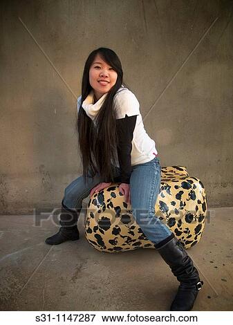 Young asian woman posing View Large Photo Image Stock Photo - Young asian woman posing. Fotosearch