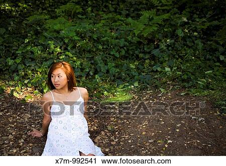 Young Asian woman waiting for someone to fill the seat beside her View Large Photo Image Stock Image - Young Asian woman waiting for someone to fill the seat beside her. Fotosearch