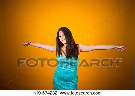 Young Asian woman with her arms outstretched. View Large Photo Image Stock Image - Young Asian woman with her arms outstretched.. Fotosearch