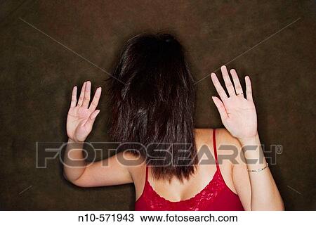 Young Asian woman with her hair covering her face View Large Photo Image Stock Image - Young Asian woman with her hair covering her face. Fotosearch