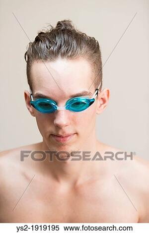 Young athletic male smimmer looking confident and wearing blue swimming goggles View Large Photo Image Stock Photography - Young athletic male smimmer looking confident and wearing blue swimming goggles. Fotosearch