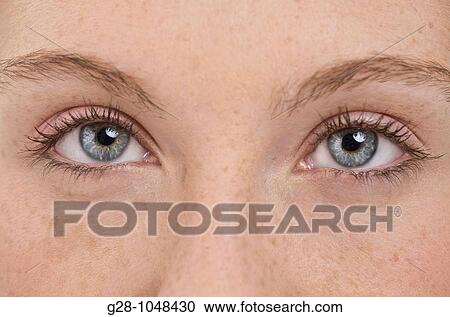 young attractive woman in green with blue eyes and long hair slightly squinting View Large Photo Image Stock Image - young attractive woman in green with blue eyes and long hair slightly squinting. Fotosearch