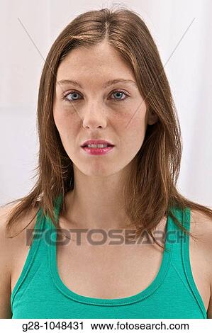 Stock Image - young attractive woman in green with blue eyes and long hair. Fotosearch