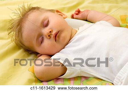 young baby girl 4 four months old sleeping in cot peacefully View Large Photo Image Stock Photo - young baby girl 4 four months old sleeping in cot peacefully. Fotosearch