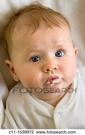 young baby girl with food on her mouth after eating View Large Photo Image Stock Image - young baby girl with food on her mouth after eating. Fotosearch