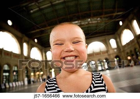 Young bald girl with pediatric cancer Leukimia looking happy and smiling in the Zurich train station, Switzerland View Large Photo Image Stock Photograph - Young bald girl with pediatric cancer Leukimia looking happy and smiling in the Zurich train station, Switzerland. Fotosearch