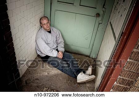 Young bald man sitting in a doorway View Large Photo Image Stock Photograph - Young bald man sitting in a doorway. Fotosearch