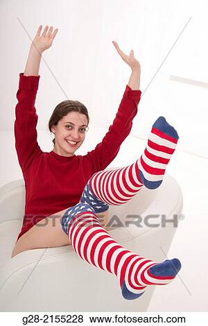young beautiful happy woman, bouncing upon a white leather armchair, with funny stars and stripes knee high socks View Large Photo Image Stock Photo - young beautiful happy woman, bouncing upon a white leather armchair, with funny stars and stripes knee high socks. Fotosearch
