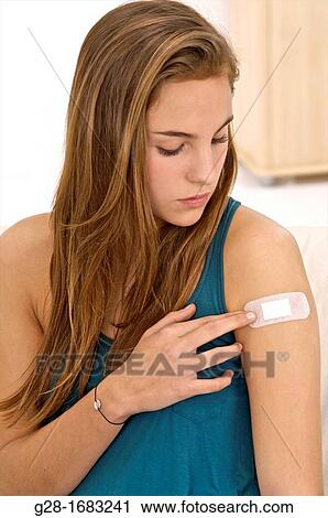 young beautiful smiling teenage girl, with a bandage on her arm View Large Photo Image Stock Image - young beautiful smiling teenage girl, with a bandage on her arm. Fotosearch