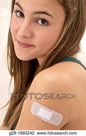 young beautiful smiling teenage girl, with a bandage on her arm View Large Photo Image Stock Image - young beautiful smiling teenage girl, with a bandage on her arm. Fotosearch