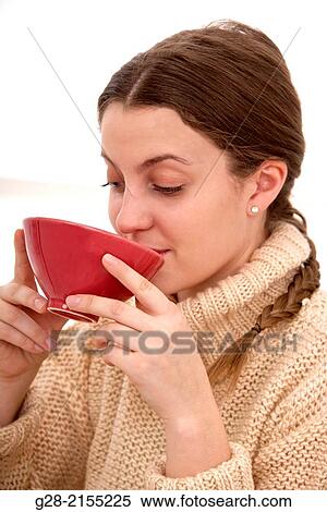 young beautiful woman drinking from a red china bowl, in a beige pull over View Large Photo Image Stock Photography - young beautiful woman drinking from a red china bowl, in a beige pull over. Fotosearch
