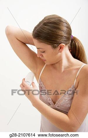 Young beautiful woman in pink underwear, spraying anti perspiration product under her arm View Large Photo Image Picture - Young beautiful woman in pink underwear, spraying anti perspiration product under her arm. Fotosearch