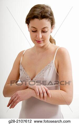 Young beautiful woman in pink underwear, holding her wrist for pain View Large Photo Image Stock Image - Young beautiful woman in pink underwear, holding her wrist for pain. Fotosearch