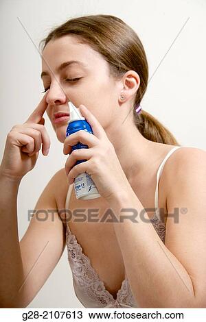 Young beautiful woman in pink underwear, cleaning one nostril of her nose with sea water spray View Large Photo Image Stock Image - Young beautiful woman in pink underwear, cleaning one nostril of her nose with sea water spray. Fotosearch