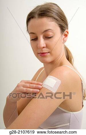 Young beautiful woman in pink underwear, putting a white dressing on her arm for pain, or wound View Large Photo Image Stock Photo - Young beautiful woman in pink underwear, putting a white dressing on her arm for pain, or wound. Fotosearch
