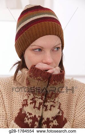 Young beautiful woman in winter woolen hat and mittens View Large Photo Image Picture - Young beautiful woman in winter woolen hat and mittens. Fotosearch