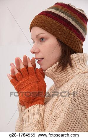 Young beautiful woman in winter woolen hat and mittens View Large Photo Image Stock Photography - Young beautiful woman in winter woolen hat and mittens. Fotosearch