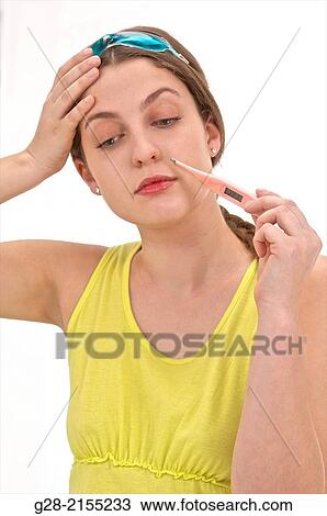 Young beautiful woman in yellow, with hot and cold pain relief mask upon her head, and hand on her forehead suffering from a headache, and thermometer in her mouth for temperature View Large Photo Image Stock Image - Young beautiful woman in yellow, with hot and cold pain relief mask upon her head, and hand on her forehead suffering from a headache, and thermometer in her mouth for temperature. Fotosearch