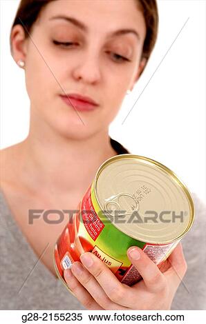 Young beautiful woman reading the label of a preserve tin View Large Photo Image Stock Photography - Young beautiful woman reading the label of a preserve tin. Fotosearch