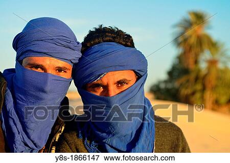 Stock Photo - Young Bedouins in the dunes at Douz, South of Tunisia. Fotosearch