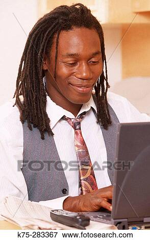 young black businessman on laptop View Large Photo Image Stock Photo - young black businessman on laptop. Fotosearch