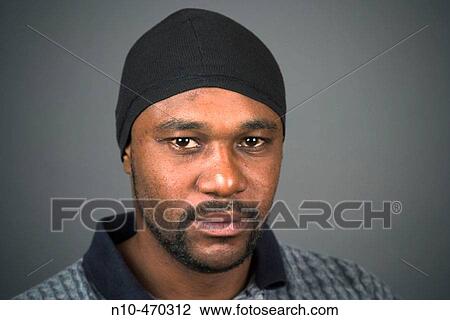 Young black man, wearing a cloth cap, posing View Large Photo Image Stock Image - Young black man, wearing a cloth cap, posing. Fotosearch