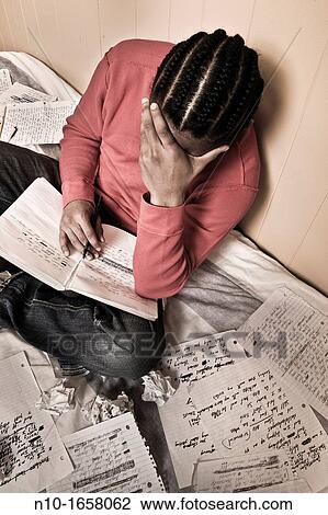 Young black man writing in his notebook View Large Photo Image Stock Image - Young black man writing in his notebook. Fotosearch