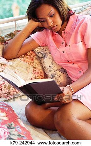 Young Black Woman reading View Large Photo Image Picture - Young Black Woman reading. Fotosearch