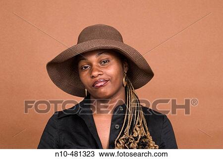 Young black woman, wearing a hat, posing View Large Photo Image Stock Image - Young black woman, wearing a hat, posing. Fotosearch