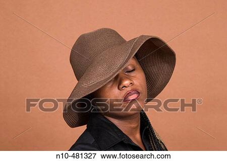 Young black woman, wearing a hat, posing View Large Photo Image Stock Photo - Young black woman, wearing a hat, posing. Fotosearch