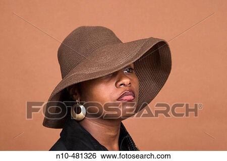 Young black woman, wearing a hat, posing View Large Photo Image Stock Photograph - Young black woman, wearing a hat, posing. Fotosearch