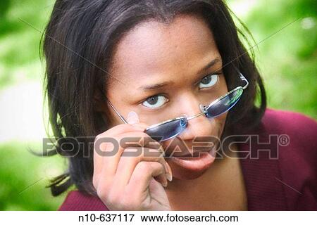 Young black woman, wearing sunglasses, posing View Large Photo Image Stock Photo - Young black woman, wearing sunglasses, posing. Fotosearch