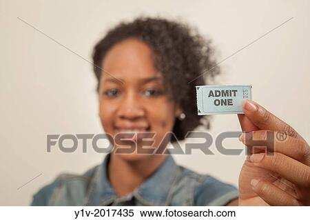 Young black woman with a ticket reading, "Admit One". View Large Photo Image Stock Photography - Young black woman with a ticket reading, "Admit One".. Fotosearch
