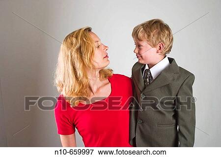 Young blond boy, who is wearing a suit, and his young blond mother posing together. View Large Photo Image Stock Photo - Young blond boy, who is wearing a suit, and his young blond mother posing together.. Fotosearch