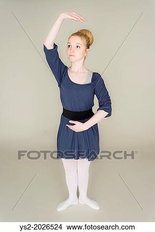 Picture - Young blond female teenager in ballet dress standing in dance pose.. Fotosearch