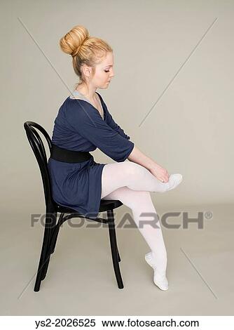 Young blond female teenager in ballet dress sitting on chair massaging foot. View Large Photo Image Stock Photography - Young blond female teenager in ballet dress sitting on chair massaging foot.. Fotosearch