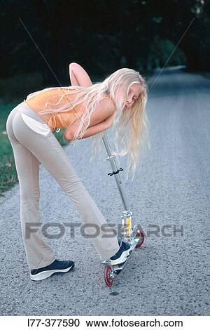 Young blond girl on scooter View Large Photo Image Stock Image - Young blond girl on scooter. Fotosearch
