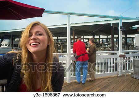 Young blond woman laughing at a marina yacht shipyard at the Texas Gulf coast View Large Photo Image Stock Photo - Young blond woman laughing at a marina yacht shipyard at the Texas Gulf coast. Fotosearch